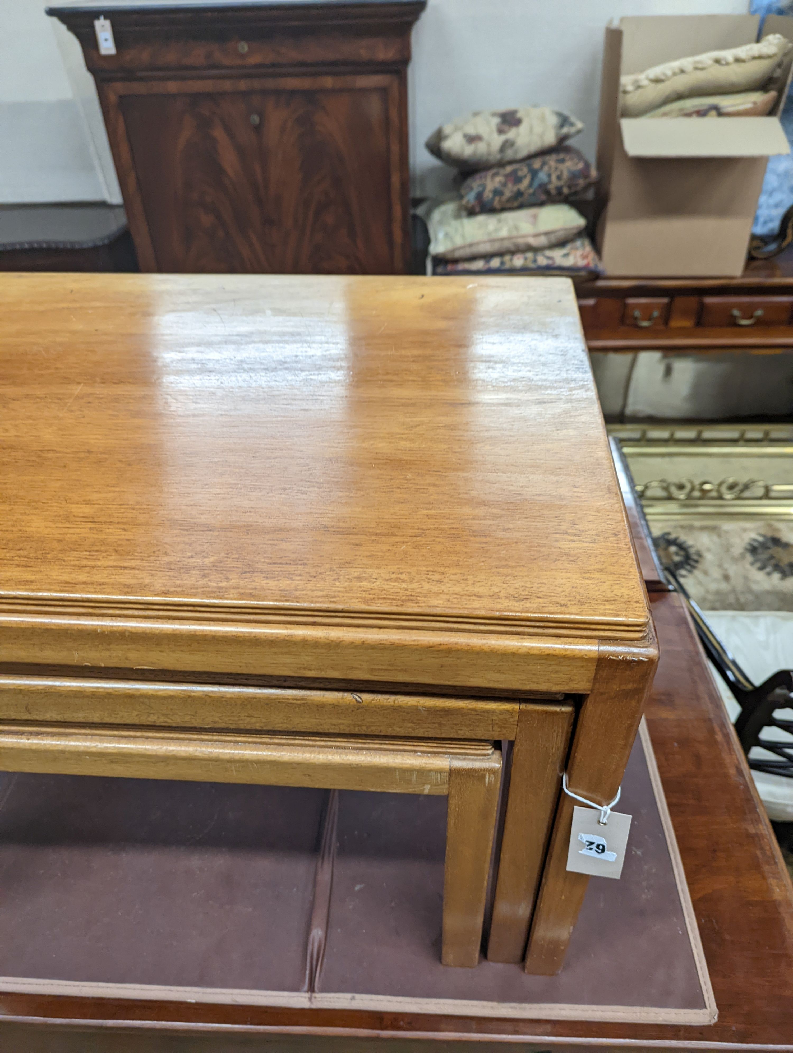 A nest of three Gordon Russell 1960's rectangular teak tea tables, width 68cm, depth 45cm, height 46cm